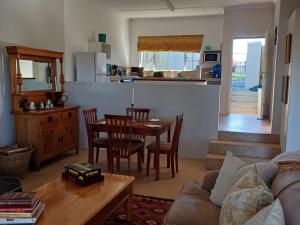 a living room with a couch and a table and a kitchen at Lake View Cottage Unit 7 in Rosetta