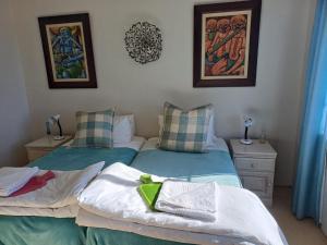 two beds in a bedroom with blue and white at Lake View Cottage Unit 7 in Rosetta