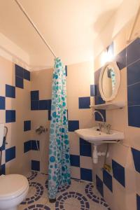 a blue and white bathroom with a toilet and a sink at PAROS APARTMENT MELAS b4 in Parikia