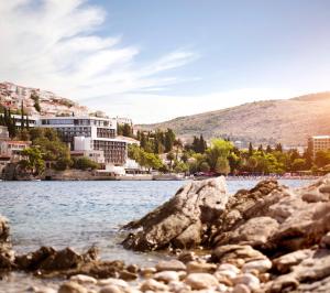 a view of a body of water with buildings at Hotel Kompas in Dubrovnik