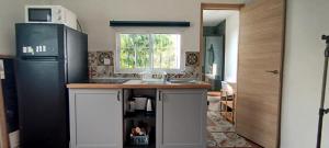 a kitchen with a sink and a refrigerator at Relax Ferrandiz in Málaga