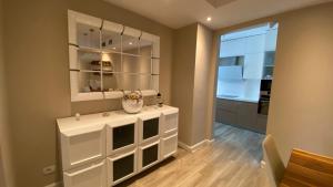 a room with a white cabinet with a vase on it at Lake Drive Rooms&Apartments in Tirana
