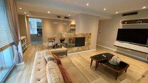 a living room with a couch and a fireplace at Lake Drive Rooms&Apartments in Tirana