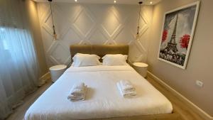 a bedroom with a bed with two towels on it at Lake Drive Rooms&Apartments in Tirana