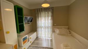 a small room with a bed and a television at Lake Drive Rooms&Apartments in Tirana +151 photos