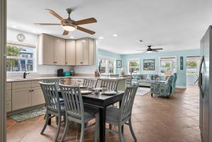 a kitchen and dining room with a table and chairs at Island Daze in Bradenton Beach