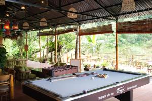 a pool table in the middle of a room at Pu Luong Riverside Lodge in Hương Bá Thước