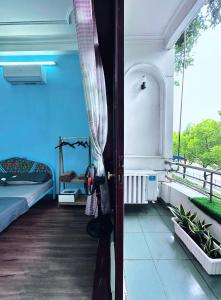 a room with a bed and a window at Gem's House 1- Balcony with Riverside View in Ho Chi Minh City