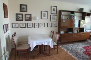 a dining room with a table and chairs and a desk at Ferienwohnung Schütze in Dresden