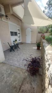 a patio with a table and a building at Apartment Modrić Zadar II in Zadar
