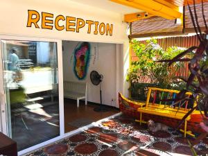 a store front with a sign that reads reception at VaoVao Hotel in Nosy Be