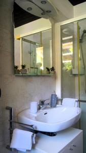 a bathroom with a white sink and a mirror at Ciceri Properties Bertarello in Baveno +10 photos