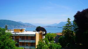 a building with a view of a body of water at Ciceri Properties Bertarello in Baveno