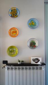 a bunch of plates hanging on a wall at Ciceri Properties Bertarello in Baveno
