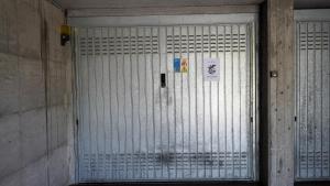 a gate in a building with signs on it at Ciceri Properties Bertarello in Baveno