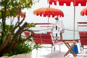 a man standing on a boat under an umbrella at Maximilian Suites in Trieste