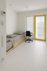 a room with two beds and a desk and a chair at City Heaven in Turku +5 photos