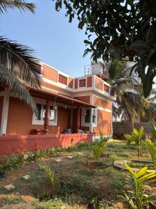a house with a balcony on top of it at MANNINA MANE Vasa in Bengaluru +17 photos