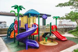 a playground with a slide and slidesktop at Halia by Kozystay - Pondok Indah in Jakarta