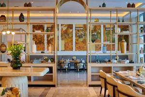 a restaurant with tables and chairs and windows at Marassi luxury suites , the Address Resort , North coast in El Alamein
