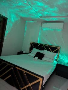 a bed in a room with an underwater ceiling at Luxury Designer Onebed Apartment in Mehar Suites Bahria Town Lahore in Lahore +78 photos