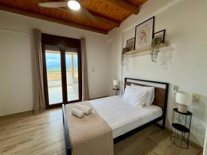 a bedroom with a large bed and a window at Aristea Seaside Retreat with Private Pool in Kalamaki Heraklion +20 photos