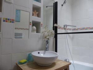a bathroom with a bowl sink and a shower at Maison des Remparts nichée sous la Cité in Carcassonne +29 photos