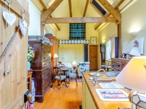 a kitchen with a sink and a table in a room at Little Tarbet in Dornoch