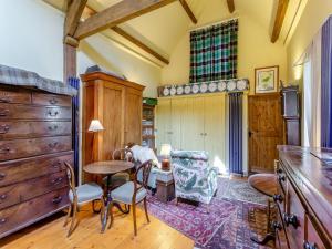 a kitchen with a table and chairs and a dining room at Little Tarbet in Dornoch