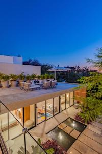 a view of a house with chairs and a patio at 3021 - La Montosa in Santa Cruz Huatulco
