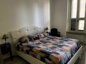 a bedroom with a bed with a colorful quilt on it at 'C'est la vie' Apartment VR20 in Gela