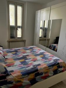 a bedroom with a bed with a colorful quilt on it at 'C'est la vie' Apartment VR20 in Gela