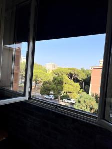 a window with a view of a street with cars at 'C'est la vie' Apartment VR20 in Gela