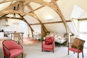 a living room with two chairs and a couch at Château de Miromesnil in Tourville-sur-Arques