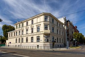 a white building on the corner of a street at Hotelik w Centrum in Toruń