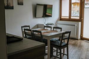 a dining room with a table and four chairs at Jakova Hiša in Kobarid