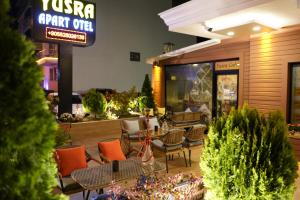 a patio with tables and chairs in a restaurant at Yusra Apart Otel in Trabzon