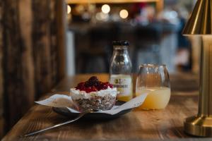 a dessert on a plate next to a glass of milk at CoDE Pod – The CoURT - Edinburgh in Edinburgh