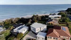 an aerial view of a house and the beach at Rennies Beach House - Luxe Coastal Stay in Ulladulla