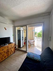 a living room with a sliding glass door to a balcony at Appartement SOL in Empuriabrava