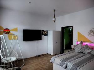 a bedroom with a bed and a flat screen tv at Casa Linda in Rotenburg an der Wümme
