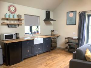 a kitchen with a sink and a counter top at Little Hare Lodge - Near Ludlow in Lane to Richards Castle