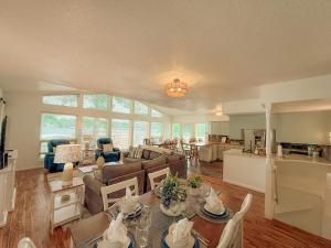 a living room with a couch and a table at Landing on Lake Time: Lakefront-4BD/2BA/Private Dock/Decks/Firepit-10PP in Gravois Mills