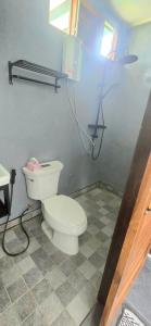 Un baño con un inodoro blanco en una habitación. en ปิงโค้งเม้าท์เท่นวิว, en Ban Yang