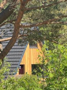 a wooden building with a gambrel roof at 1 Bedroom Cabin with Mountain & Loch Views - Quiet Location between Glencoe & Ben Nevis in Corran