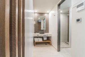 a bathroom with a sink and a mirror at Atrion Resort Hotel in Agia Marina Nea Kydonias