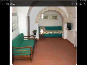 a room with a bed and a couch and a television at Villa CasinaSanDonato in San Donato