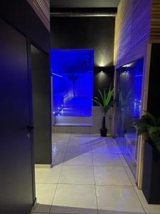 a hallway with blue lights in a building at Appart Quartier Louise Bruxelles in Brussels