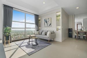 a living room with a couch and a large window at Halia by Kozystay - Pondok Indah in Jakarta