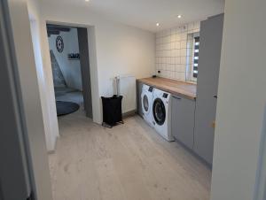 a laundry room with a washer and dryer at Lütt achtern Diek in Neufeld +17 photos